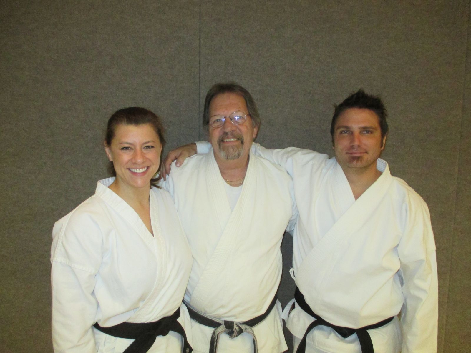 Three black belts smiling