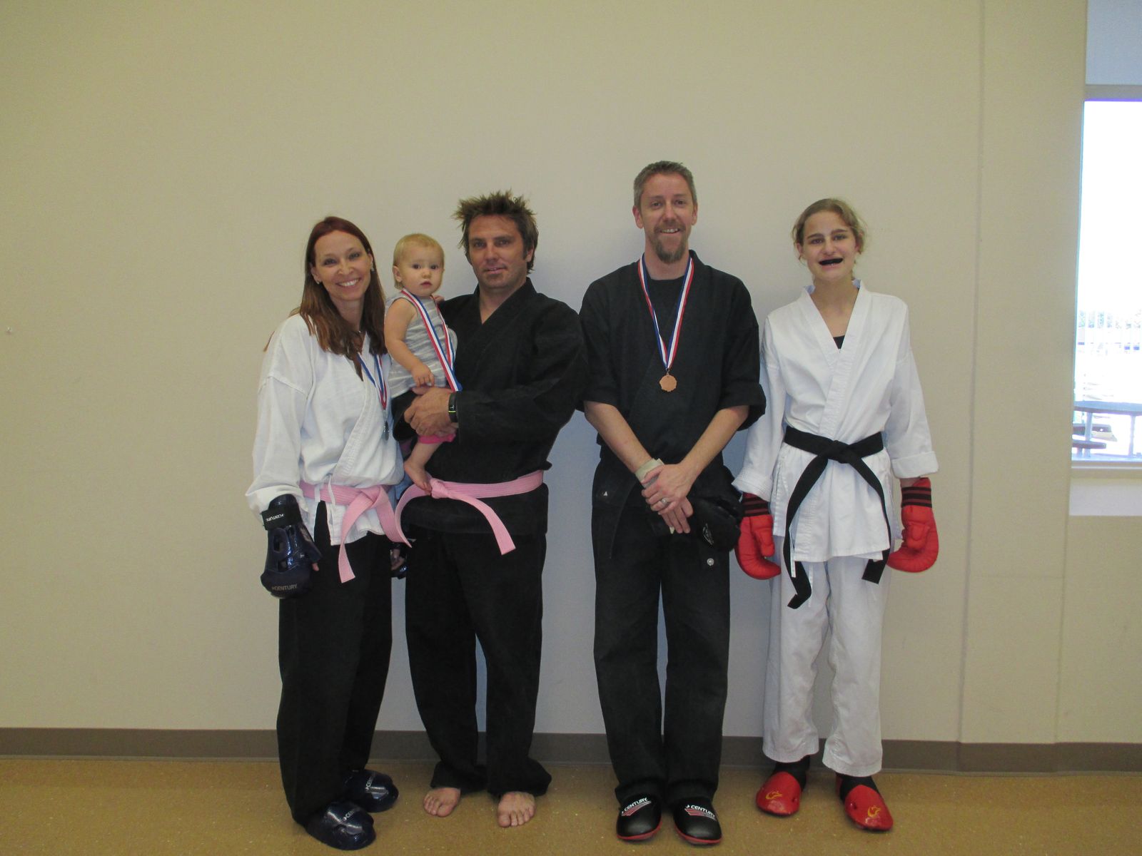 A family of students with their tournament medals