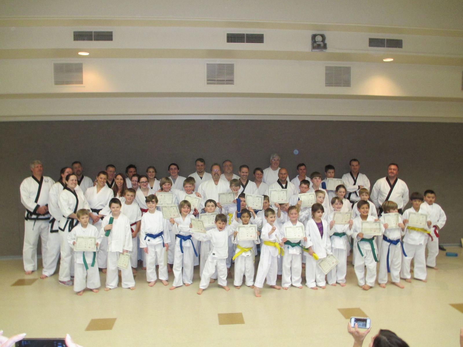 A large group of students of all ranks after a belt test