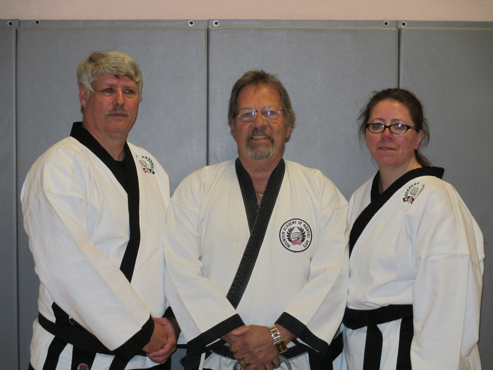 Three black belts in their 50s and 60s
