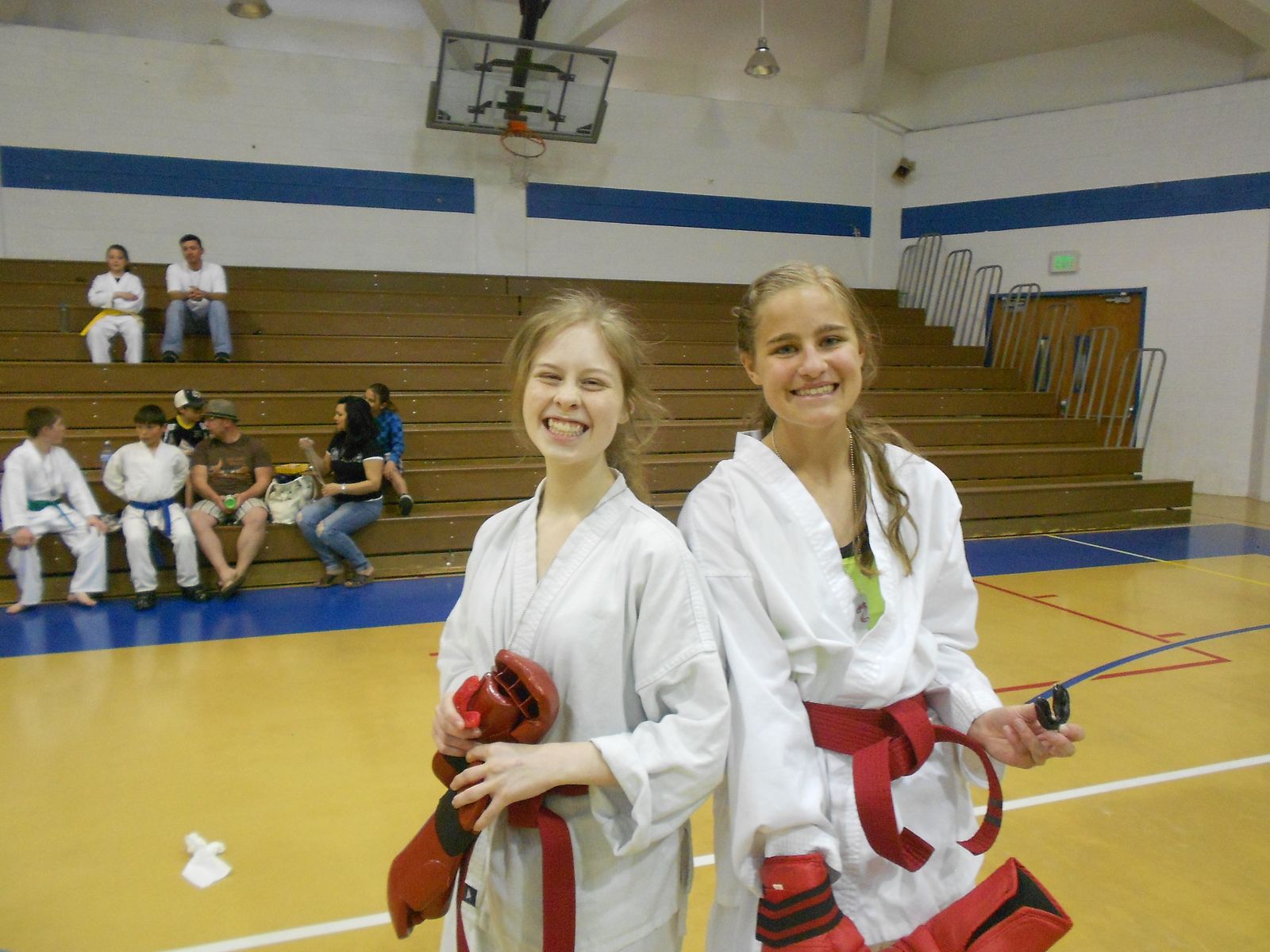 Two teenage students in sparring gear